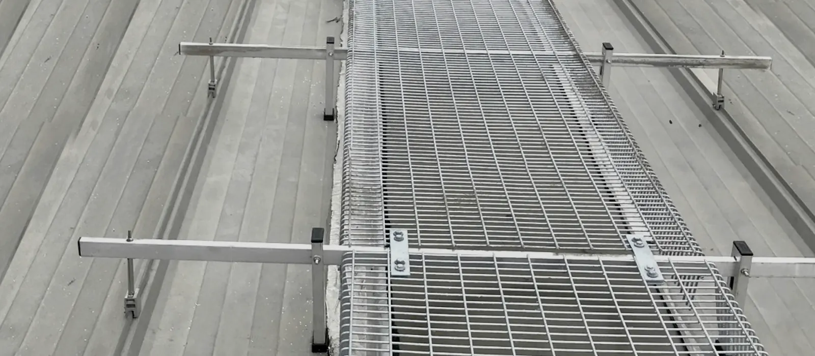 Aluminium walkway and safety mesh installed across an industrial roof