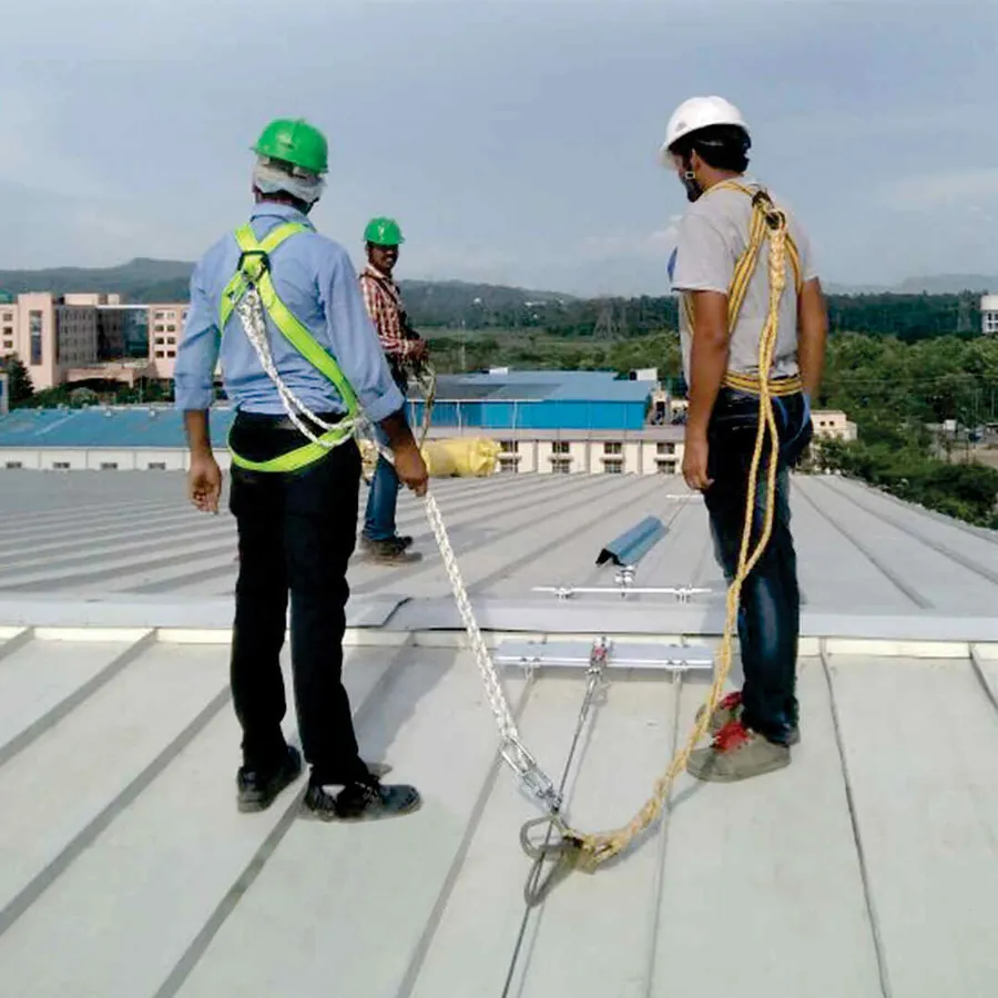 Workers secured to a horizontal lifeline on an industrial roof